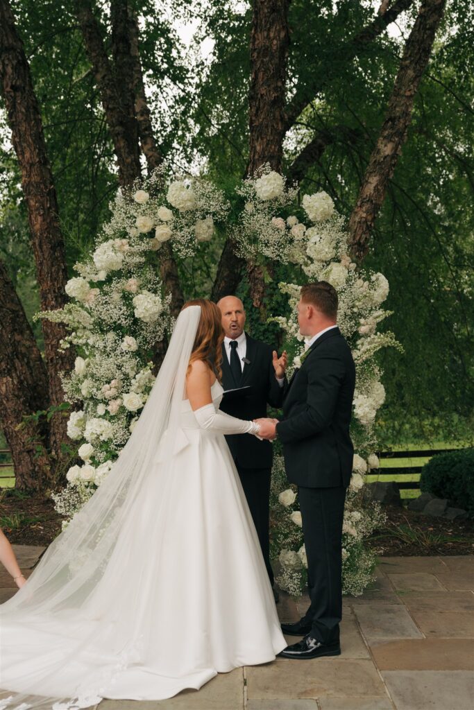 bride and groom holding hands at their wedding ceremony 