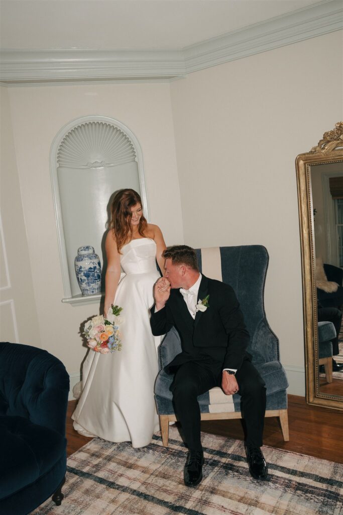 groom kissing the brides hand