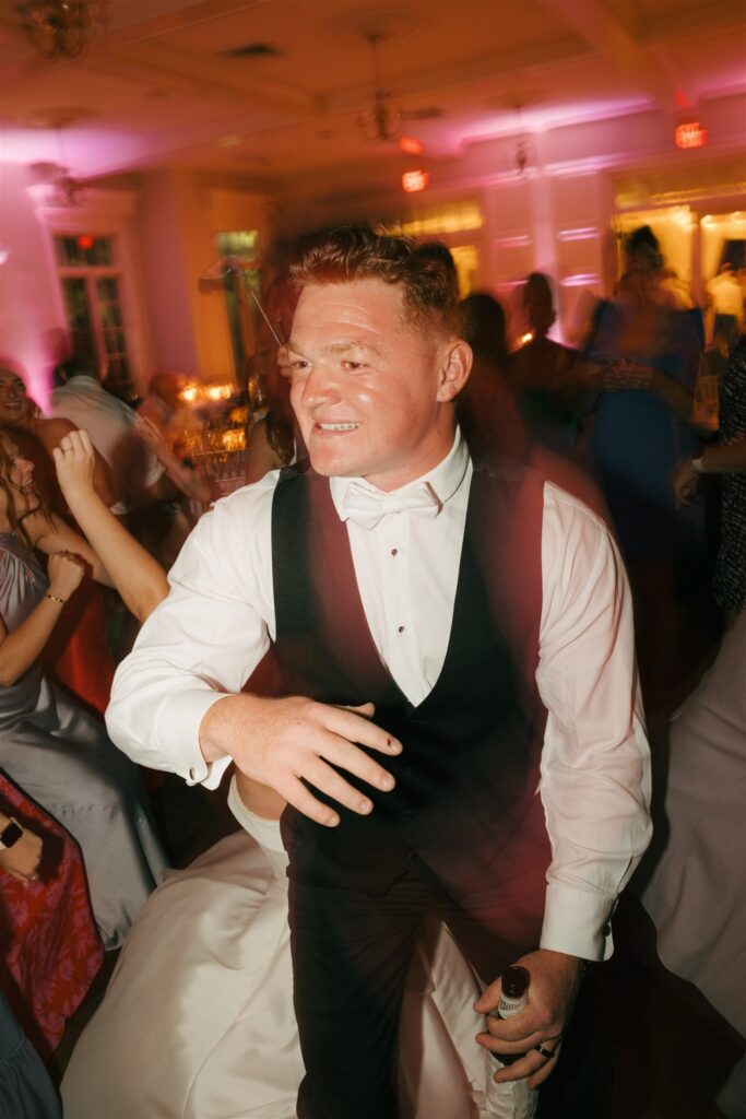 groom dancing at his wedding party