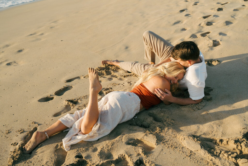 couples cuddling on the beach