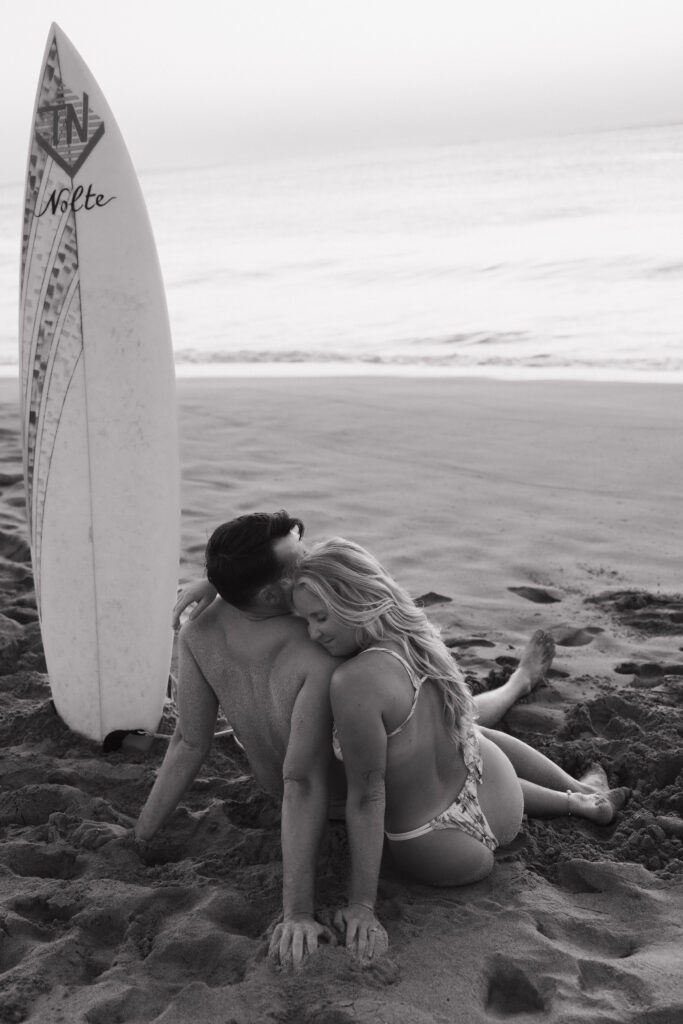 black and white couple with a surfboard