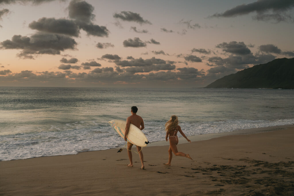 couple surfing in oahu 