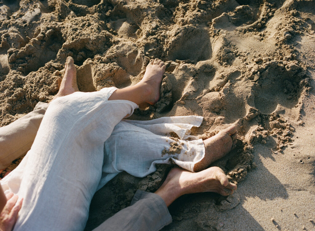 sandy feet on the beach detail photo