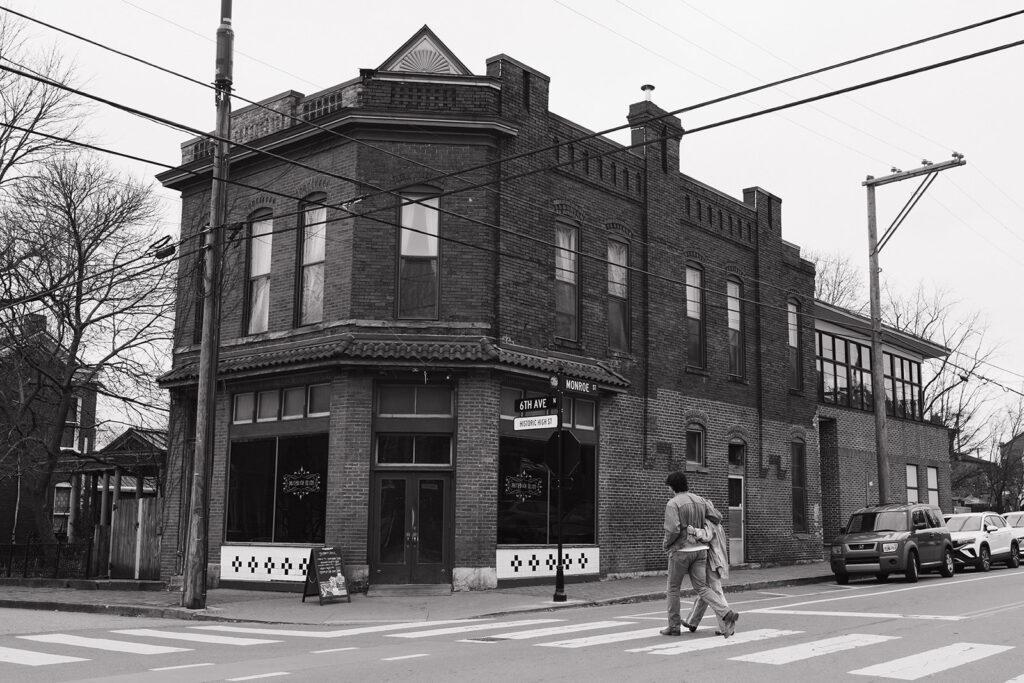 wide shot of couple crossing the street 