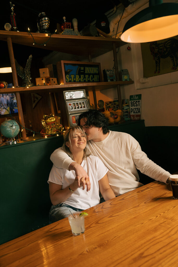 couple sharing kisses at a bar 