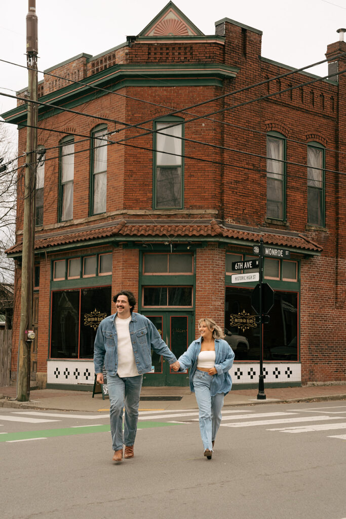 couple running across the street in Nashville 