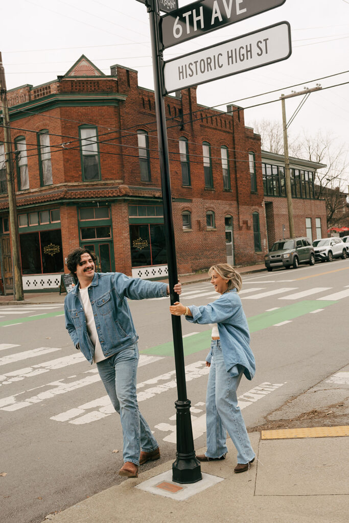 carefree couple swinging around lamp post Germantown 