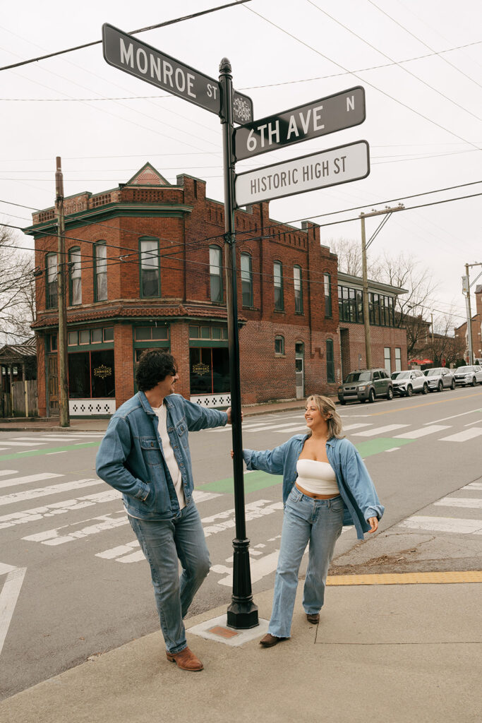 couple swinging around lamp post 