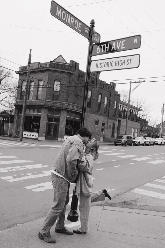 black and white couple kissing at a lamp post 