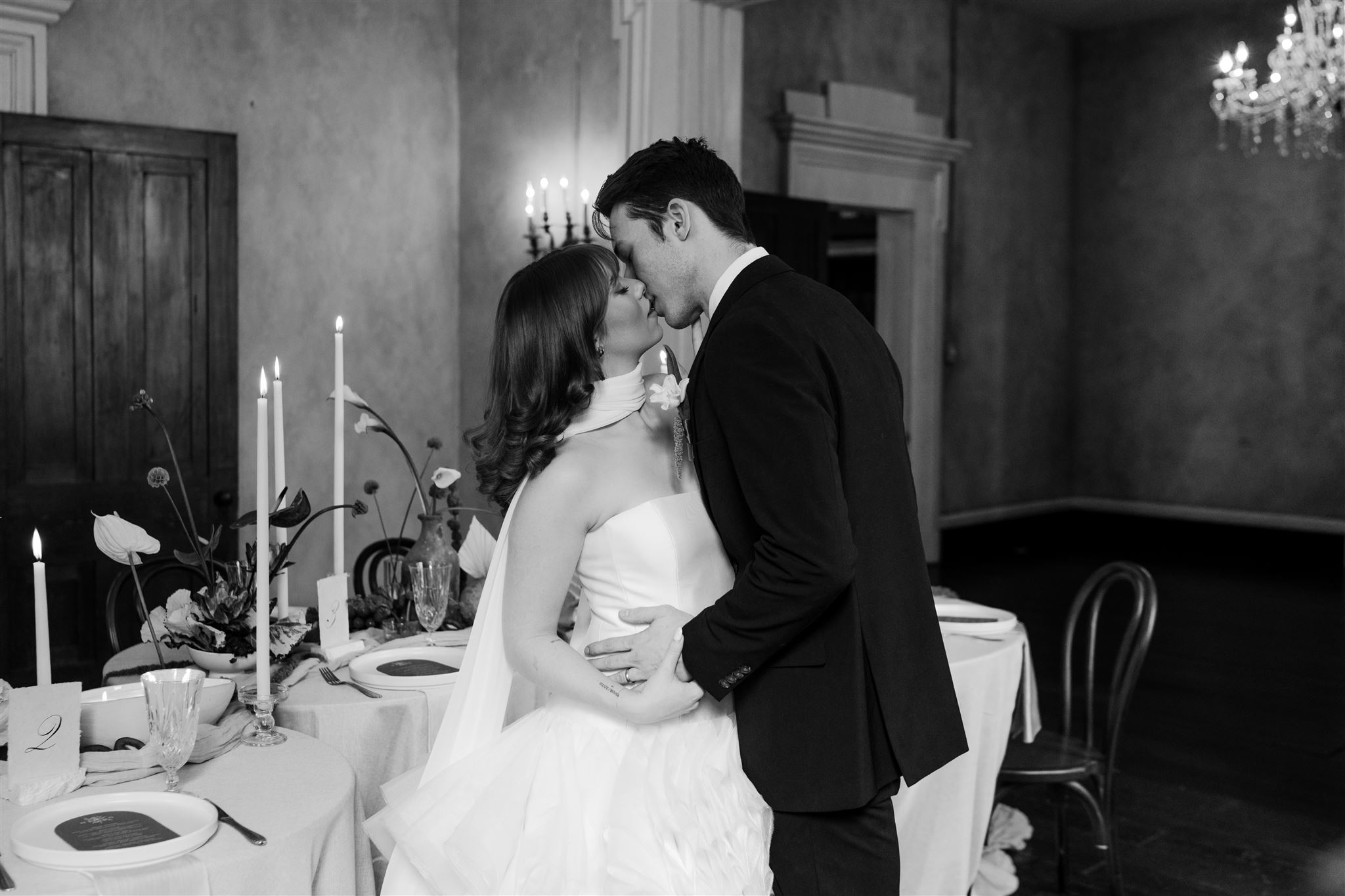 black and white bridal couple leaning in for a kiss