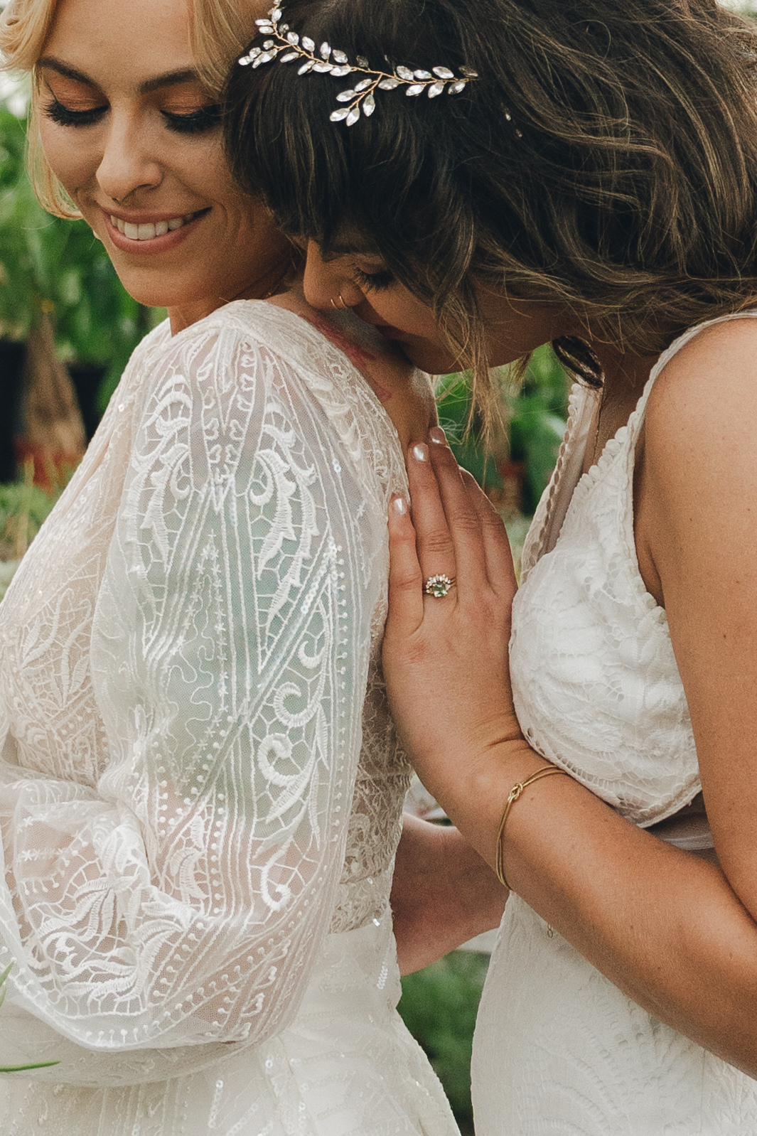A bride kisses her bride's shoulder