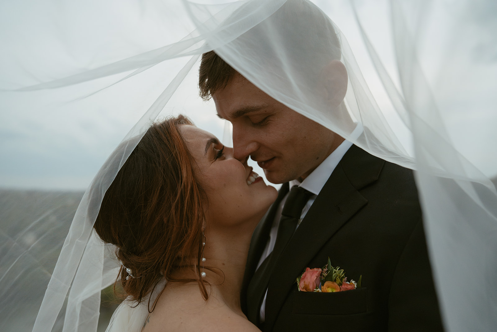 Newlyweds lean in for a kiss hiding under the veil during their Nashville Elopement