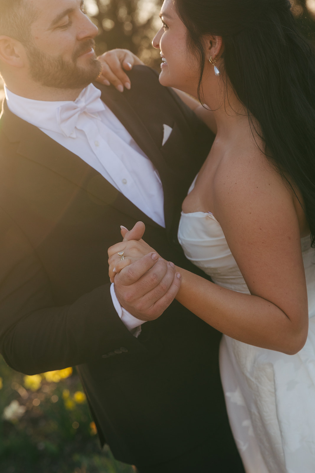 Closeup of newlyweds dancing in the sunset holding hands smiling at each other during their Nashville destination wedding