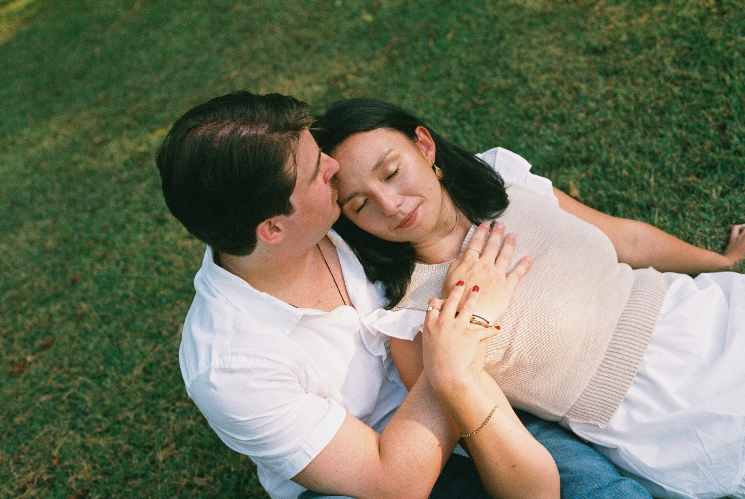 Freshly engaged couple laying down closing their eyes in Nashville, Tennessee.