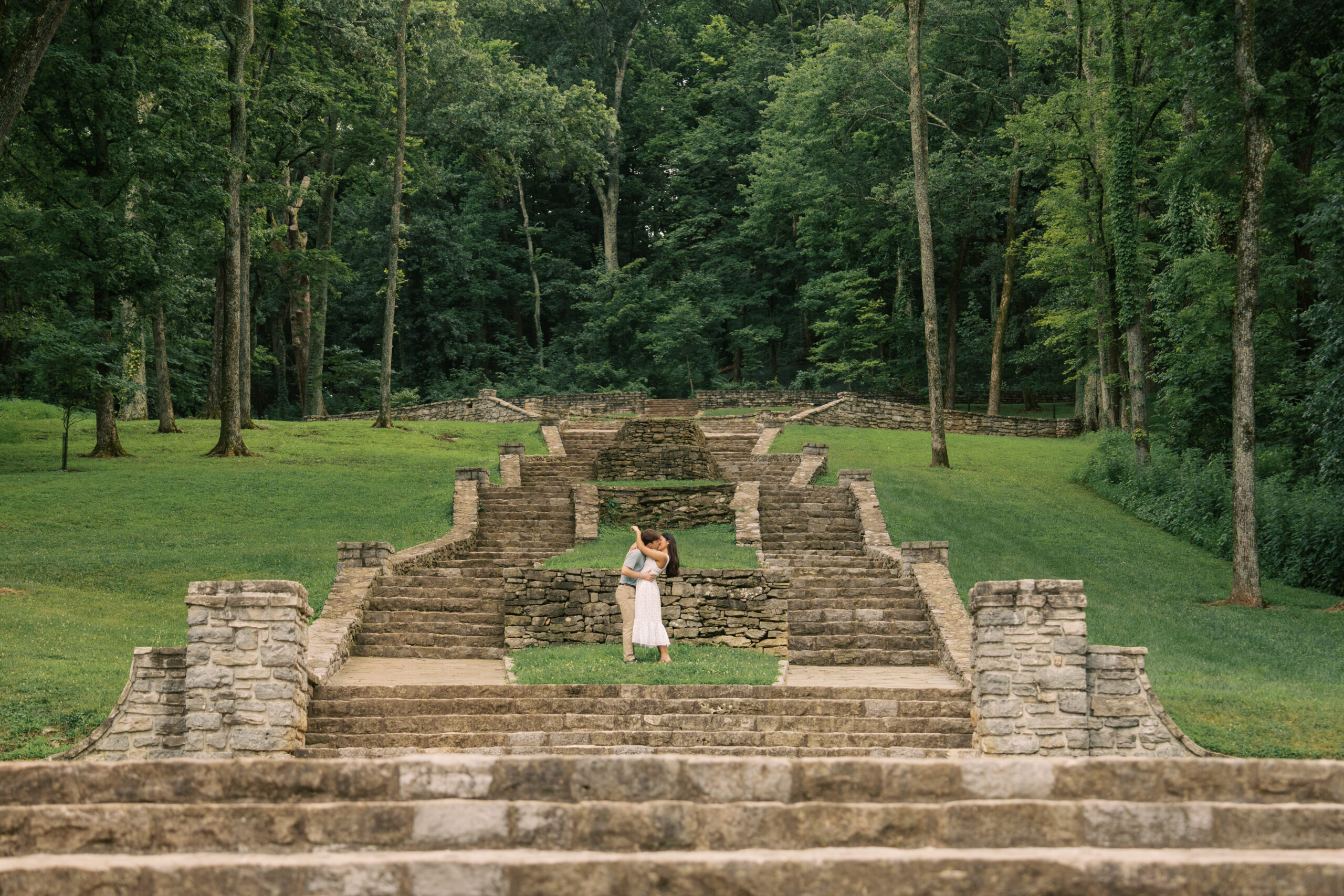 Couple kissing on the stairs at Percy Warner Park in Nashville Tennessee.