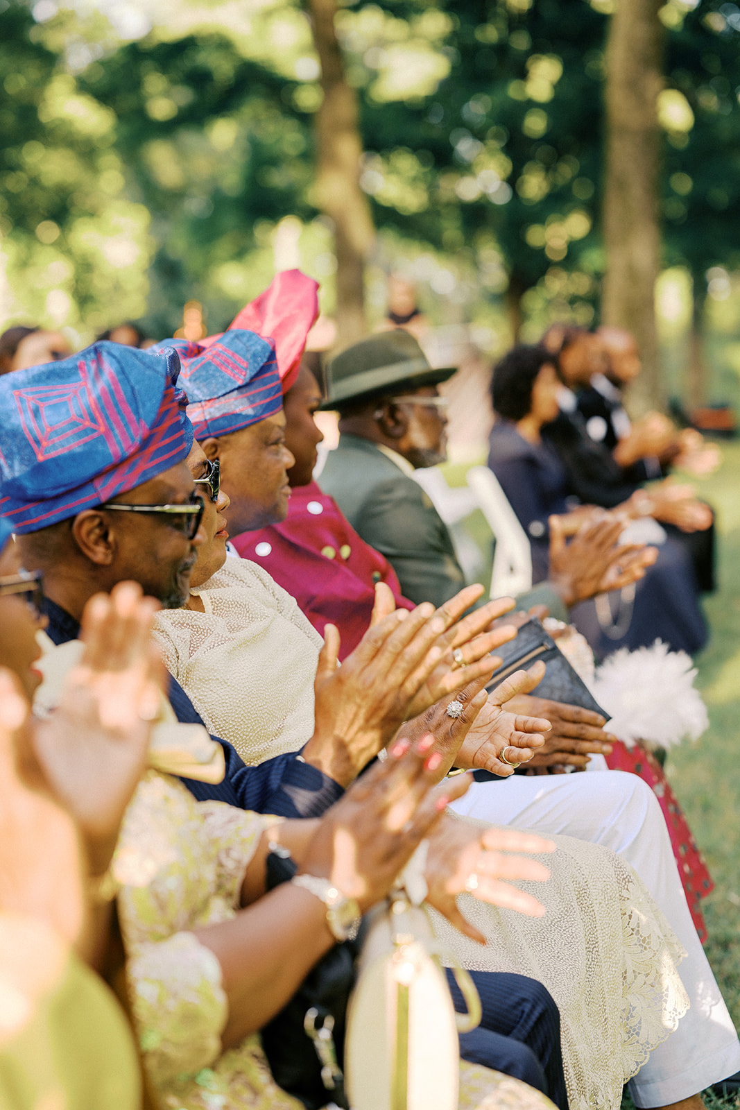 People capping during a wedding ceremony in nashville wearing colorful clothing.