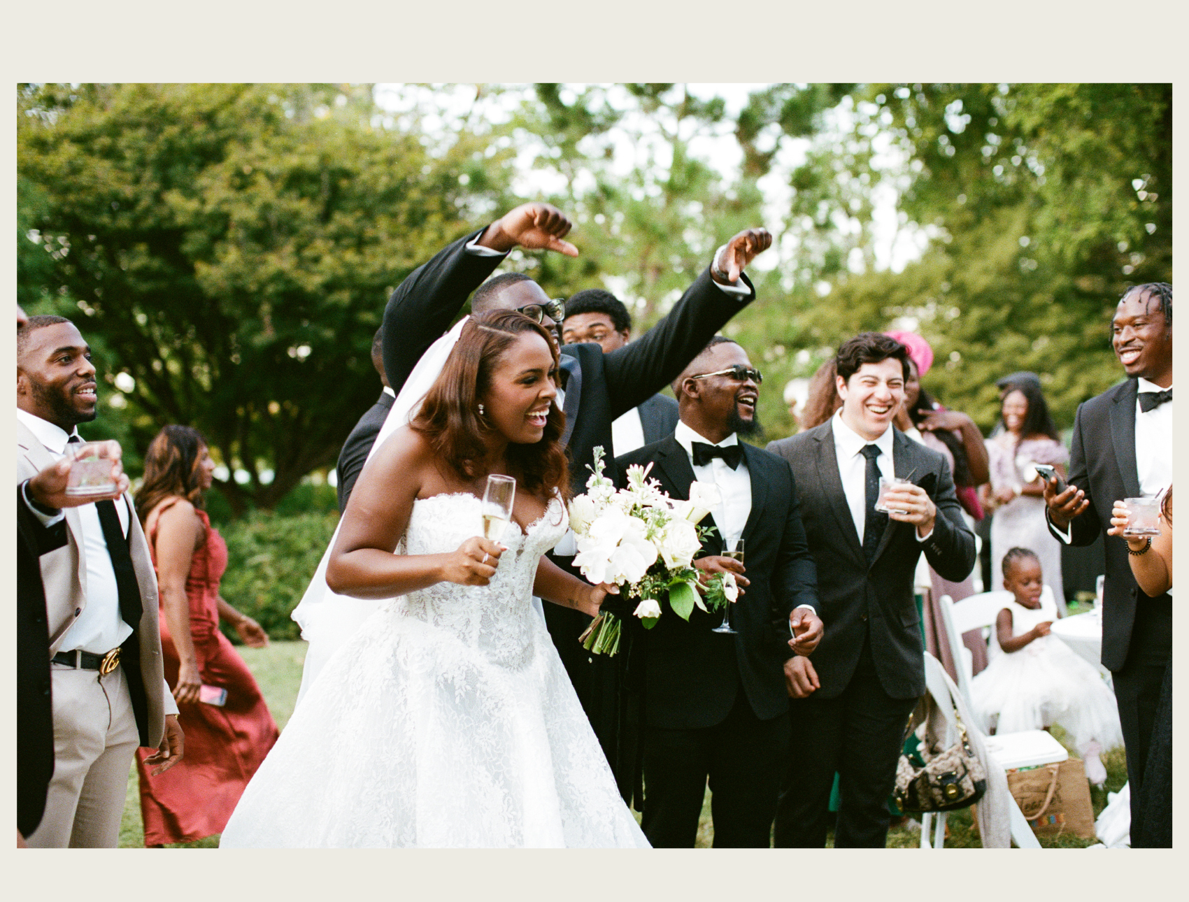 a bride and her bridal party screaming with joy with champagne in their hands. photo by nashville best wedding photographers, jaimee raneigh photography.