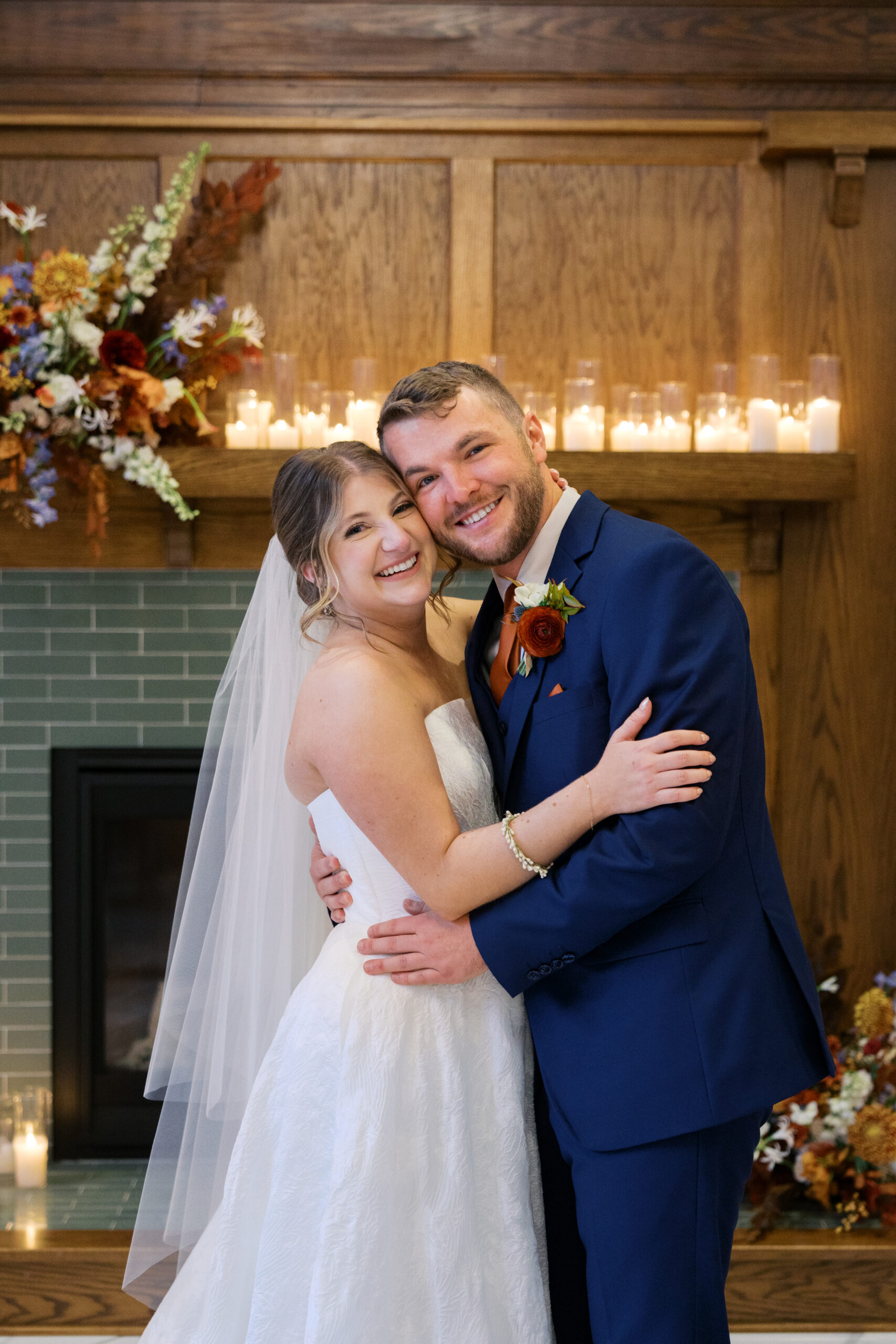 A newlywed couple in a blue tux and a white wedding dress holding each other looking at the camera smiling on their wedding day at hotel morgan. 
