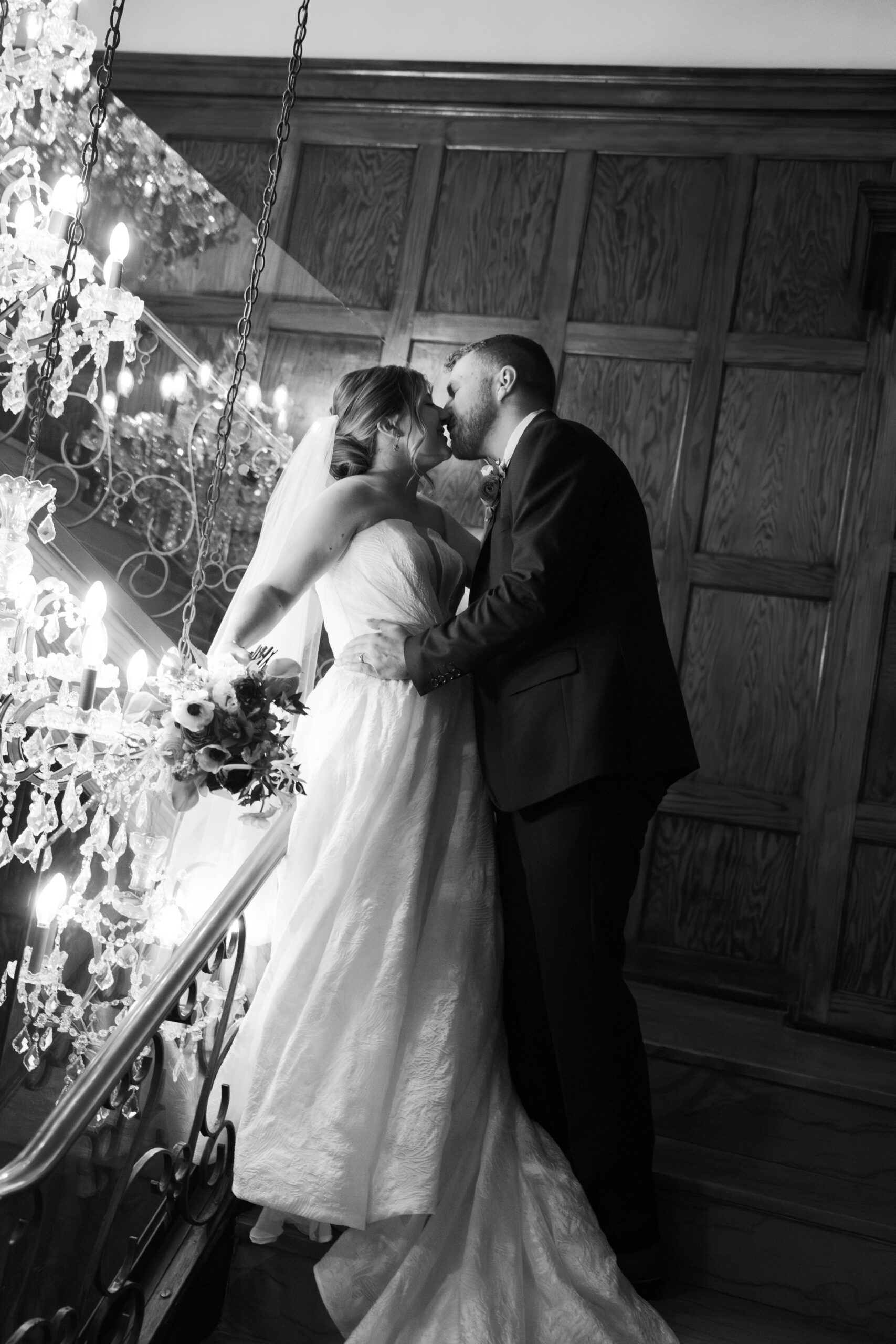 black and white photo of a couple kissing on the steps of hotel morgan in morgantown, west virginia