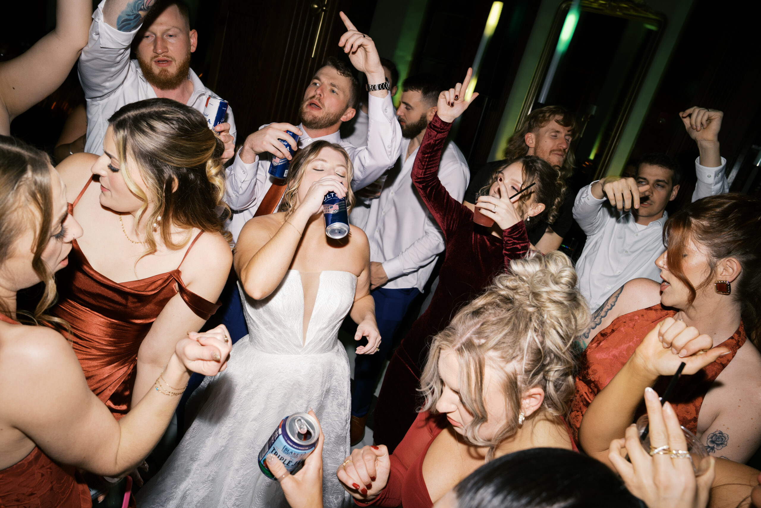 a handful of wedding guests drinking beer and partying at a hotel morgan wedding day in december 2025