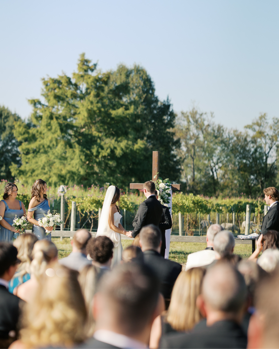 a bride and groom hand in hand at the front of the altar during their wedding ceremony in tennessee