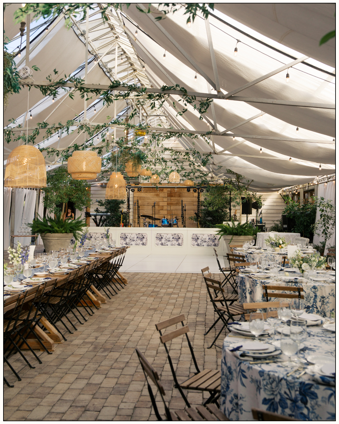 a reception tablescape full of greenery and blue tablecloths at long hollow gardens
