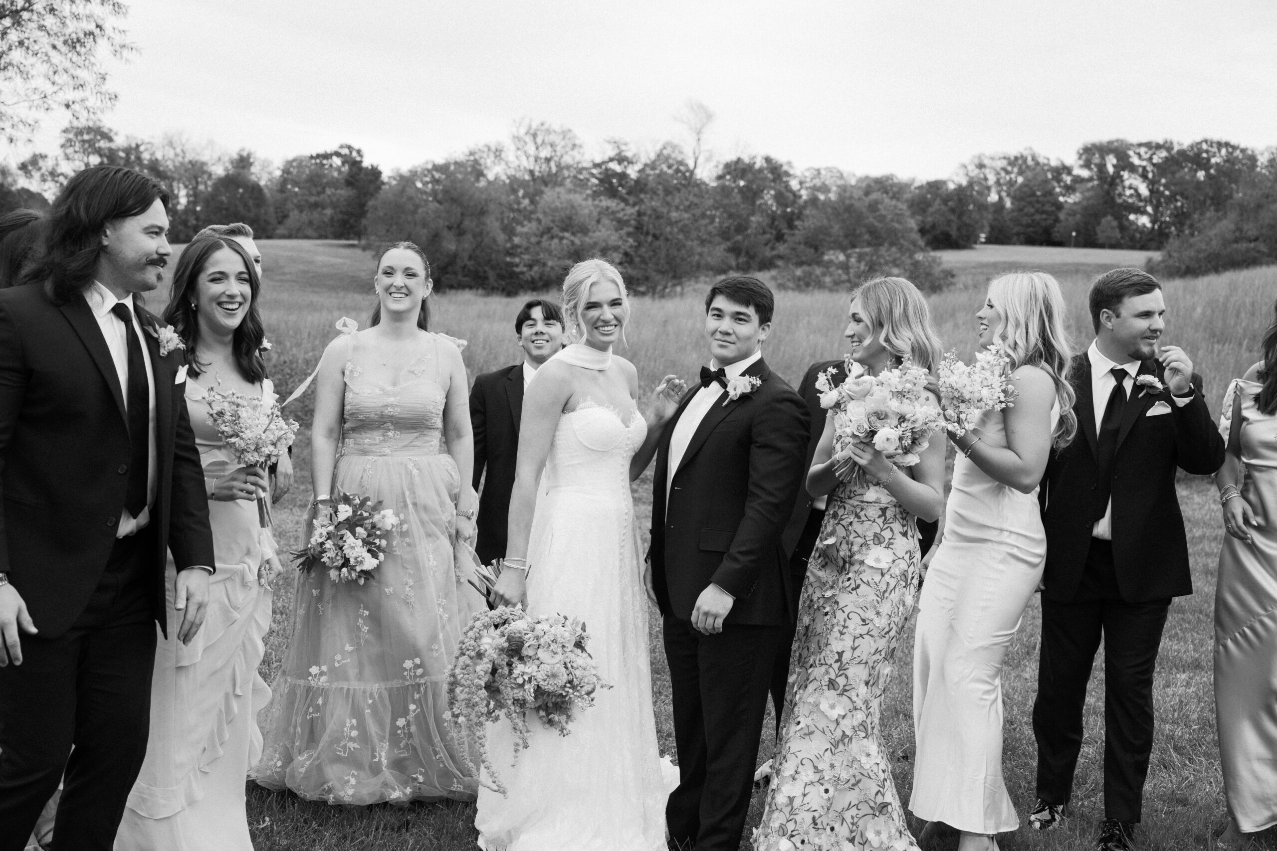 a bridal party photo of them smiling in black and white at stone haven wedding venue in section alabama 