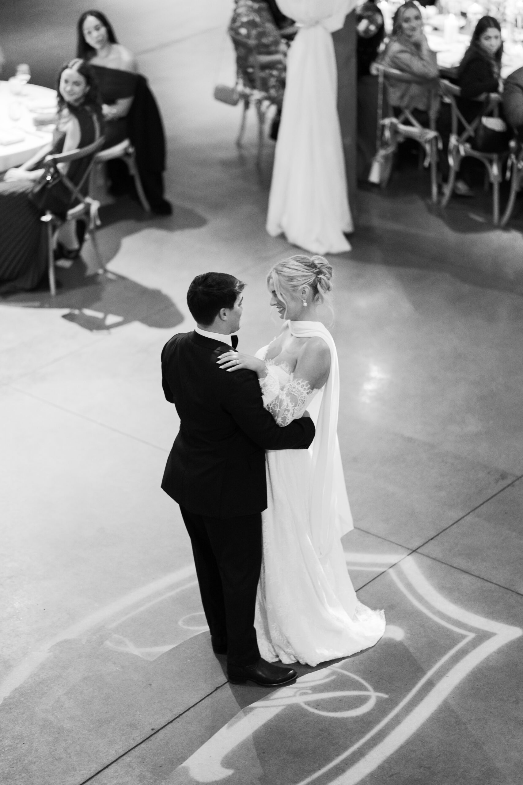 a bride and groom sharing their first dance at their wedding at stone haven in black and white. 