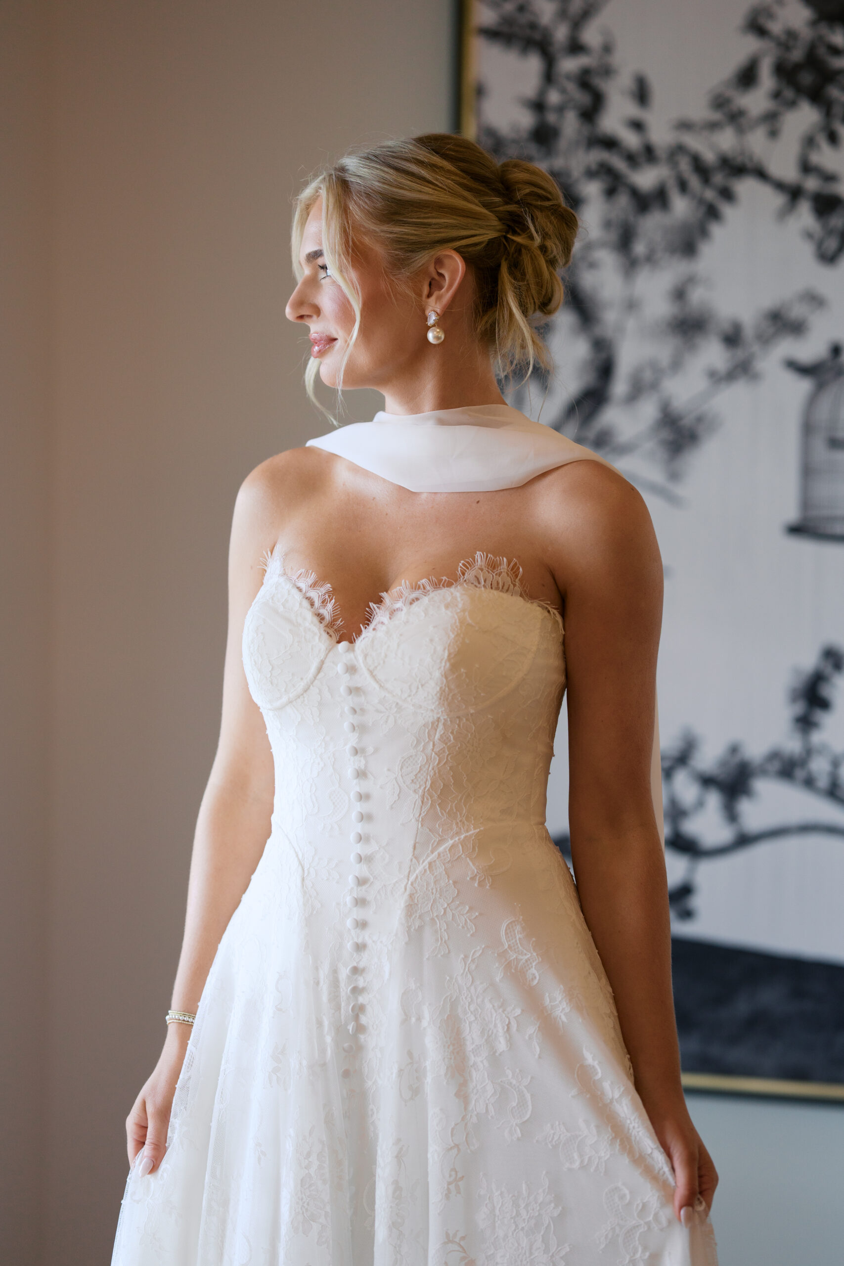 A bride looking out the window in her wedding dress at a tennessee wedding venue. 