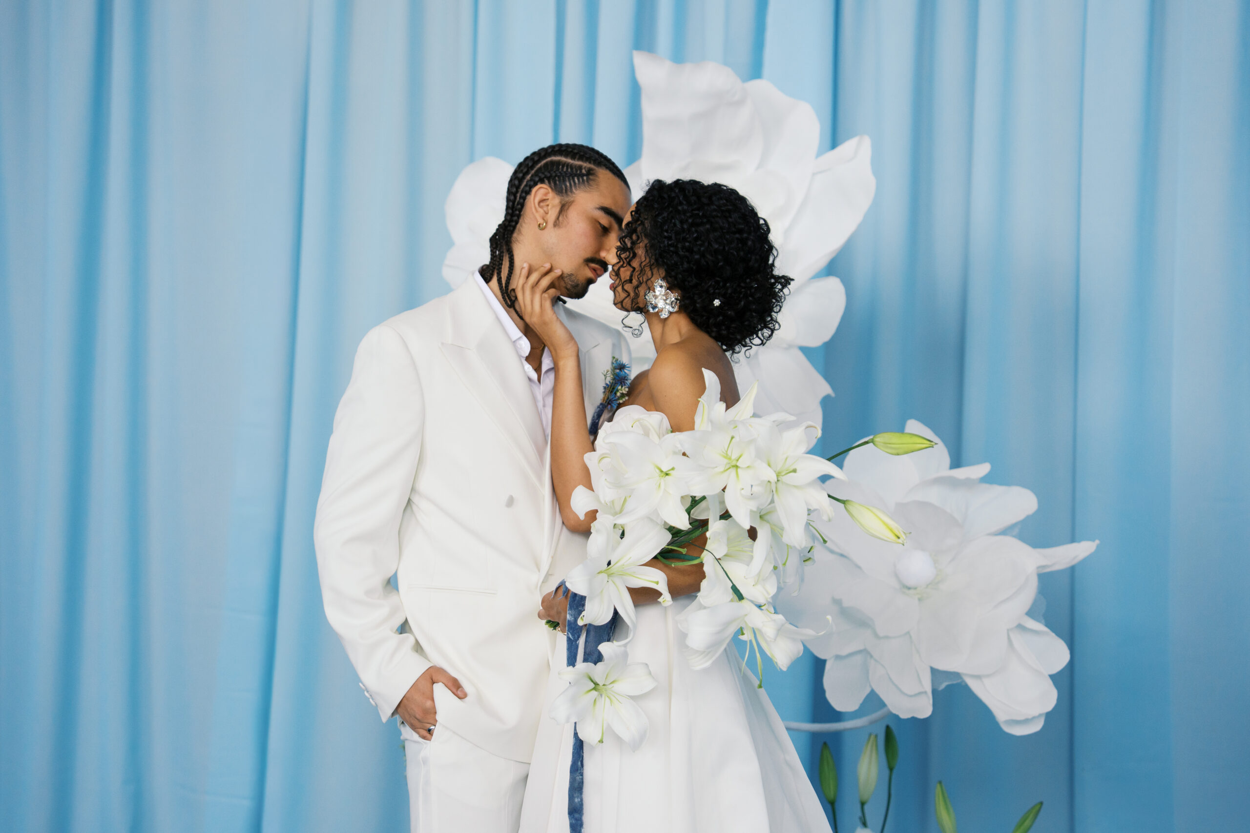 a couple in all white kissing on their wedding day at diamond creek farms in nashville tennessee