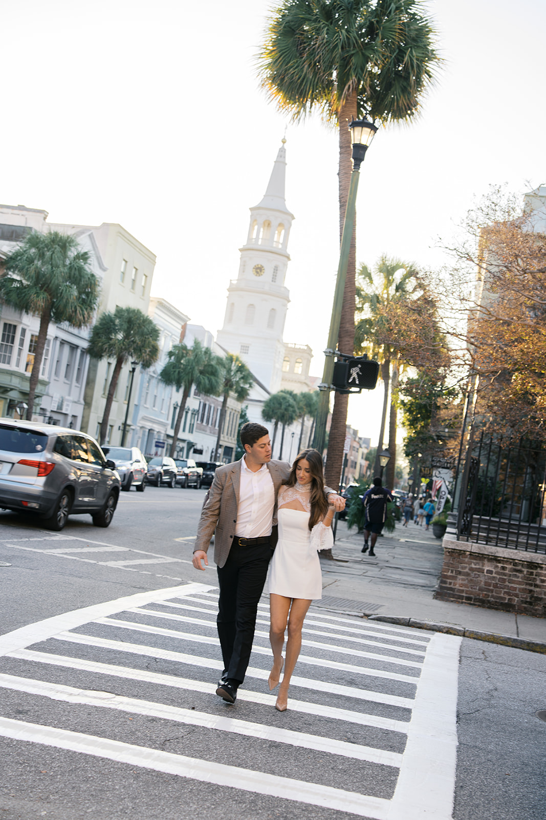 A couple walking and holding hands in charleston.