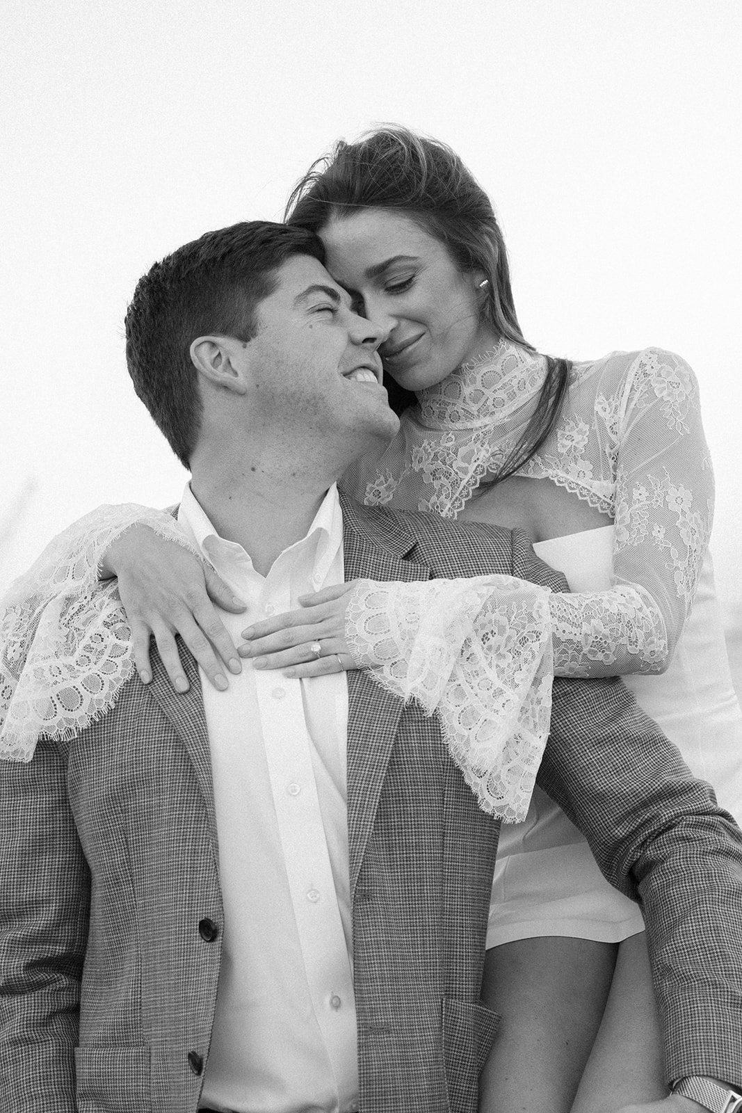 A black and white photo of a couple holding onto each other in south carolina during their engagement photo session
