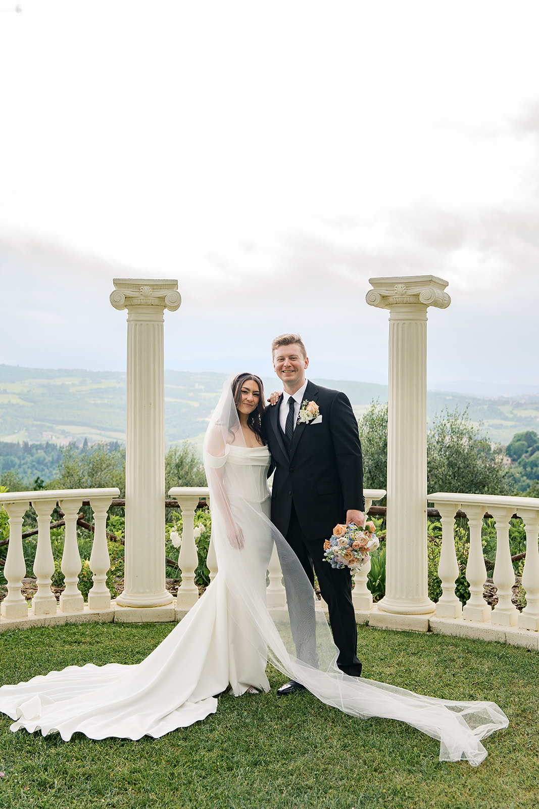 A bride and groom portrait with the italian countryside in the background