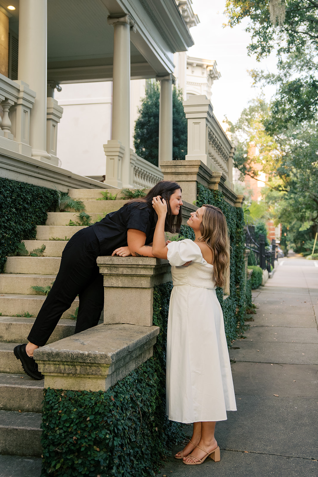 Two brides looking at each other during their engagement session in savannah. 