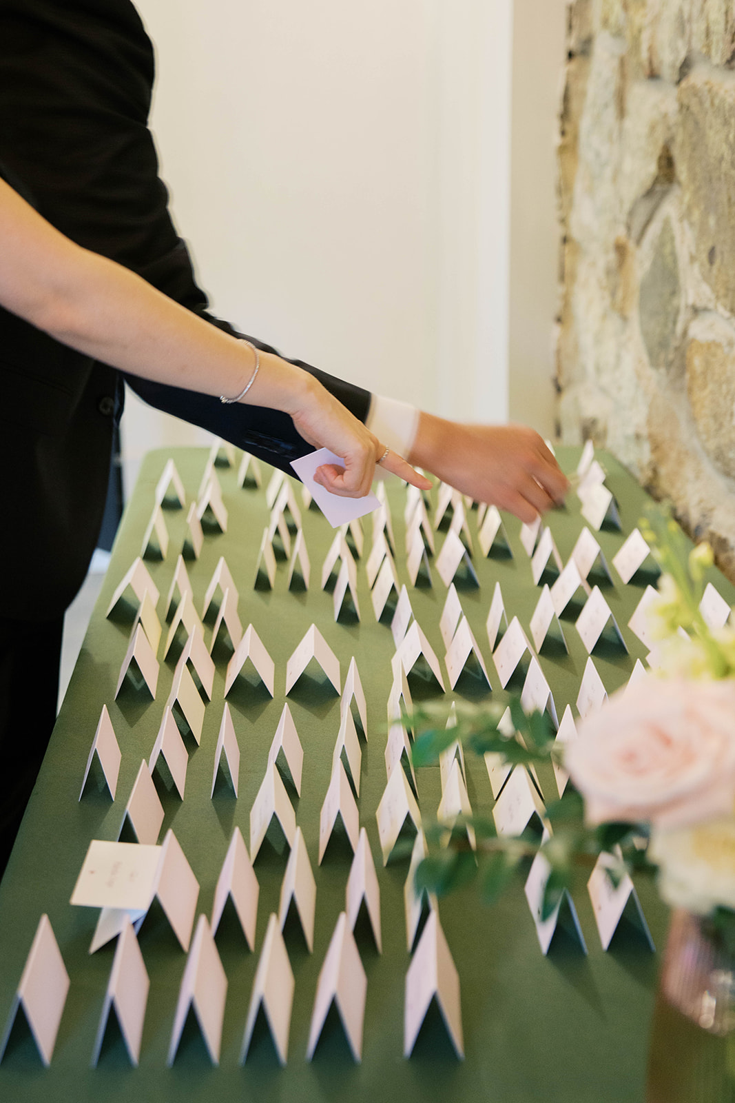 Guests during a wedding reception at the view at bluemont choosing their placecards.