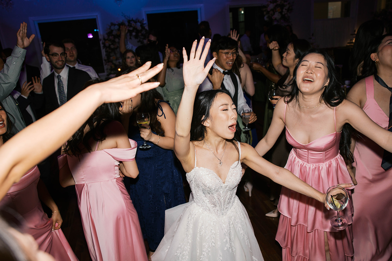 A bride with her hands up singing during her wedding reception in northern virginia.