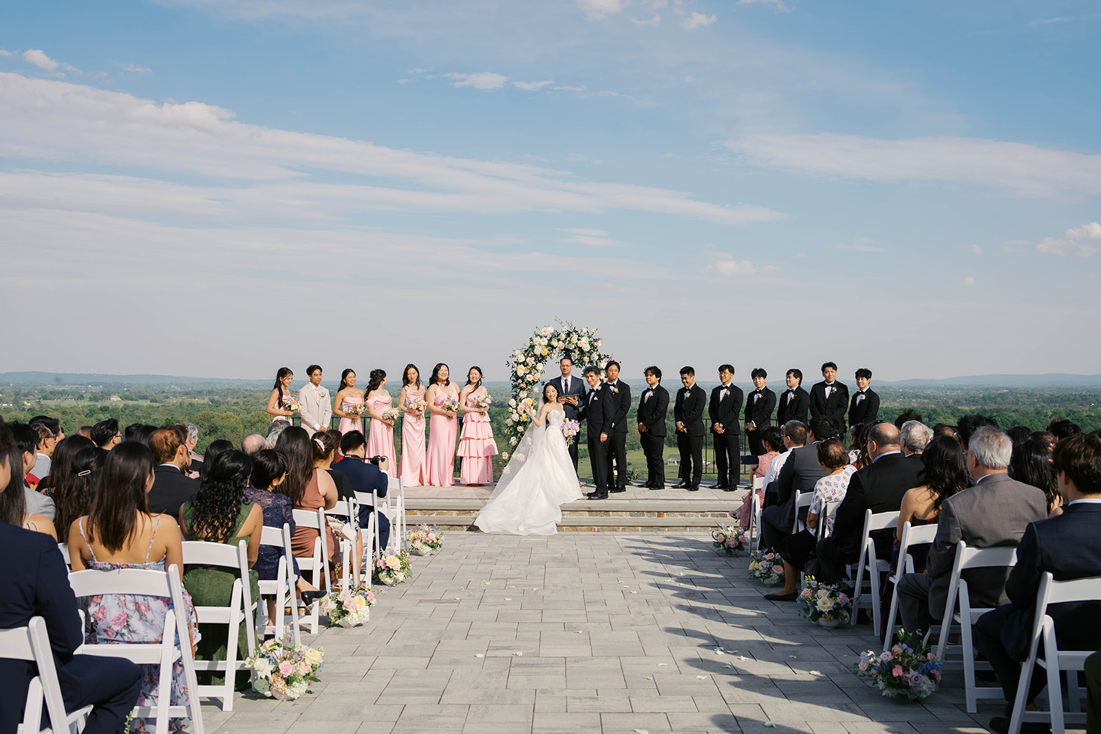 Couple standing at the altar at the view at bluemont waiving to their guests during their wedding ceremony. Photos by Jaimee Raneigh Photography.