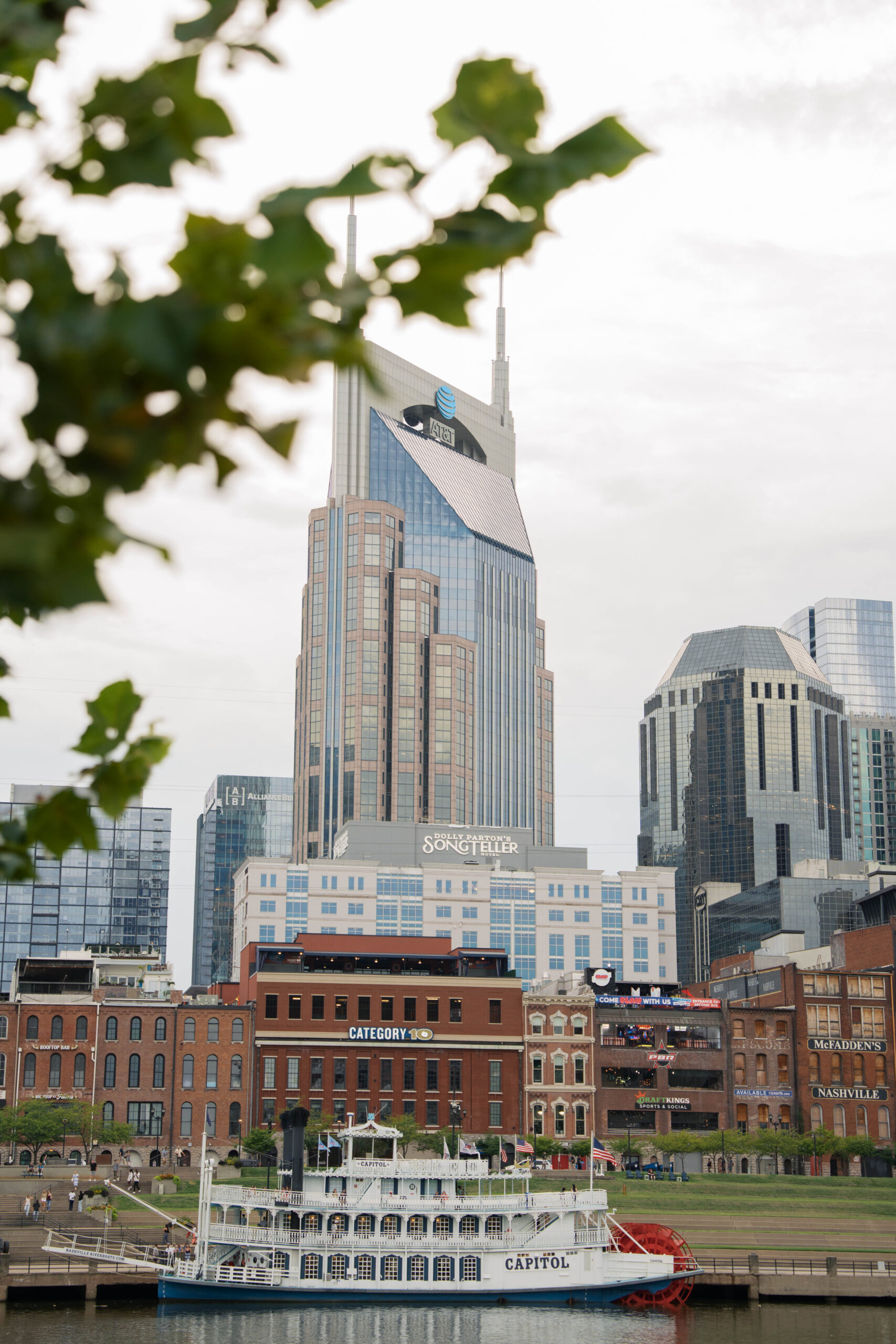 A photo of the batman building in nashville with a river boat cruise on the Cumberland.
