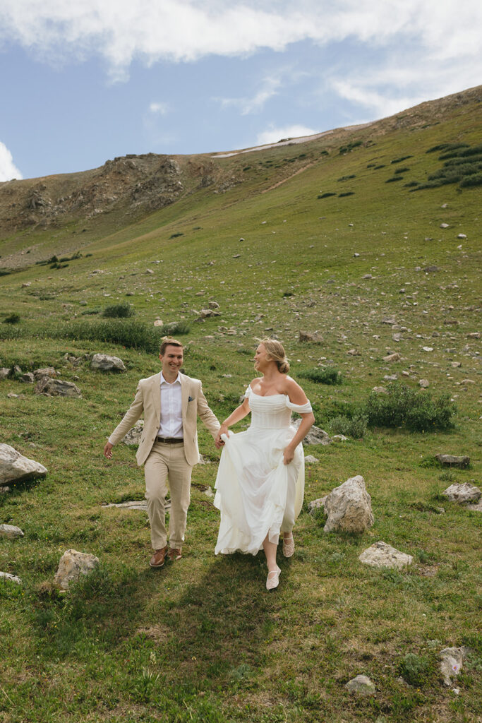 bride and groom running holding hands