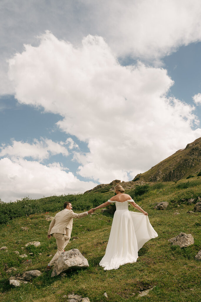 bride and groom holding hands