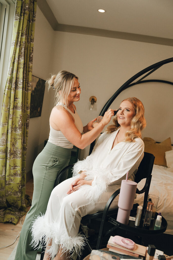 bride getting her makeup done for her wedding ceremony 