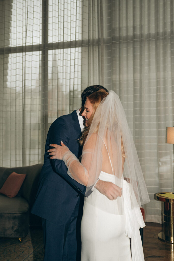 bride and groom hugging after their first look