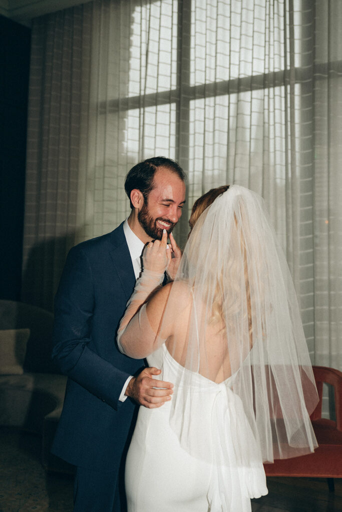 bride and groom smiling at each other 