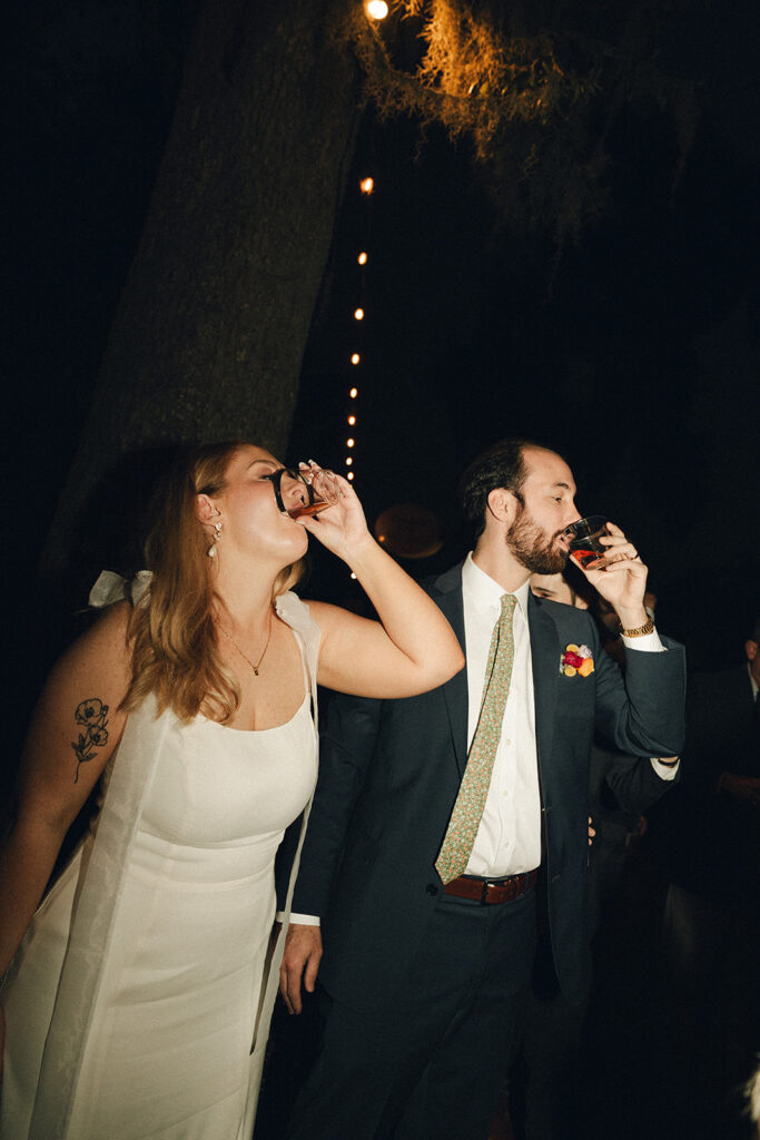 bride and groom taking a shot 