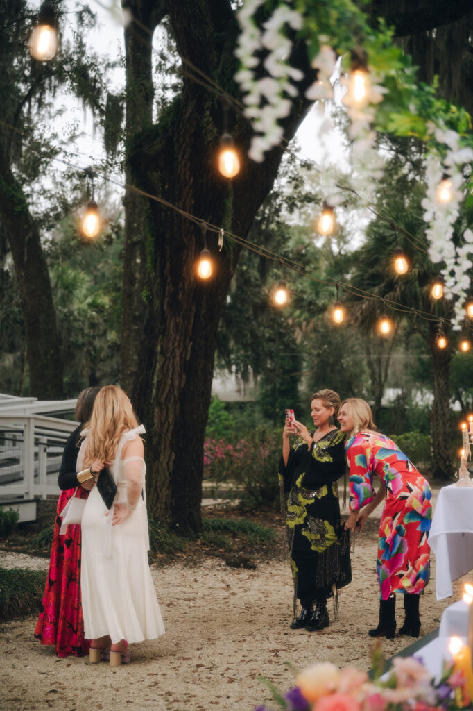 bride taking picture with her wedding guests