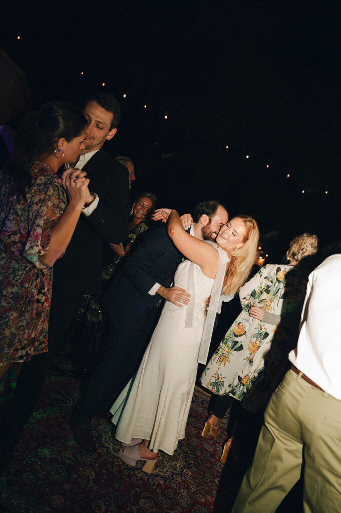 bride and groom hugging at their garden themed wedding