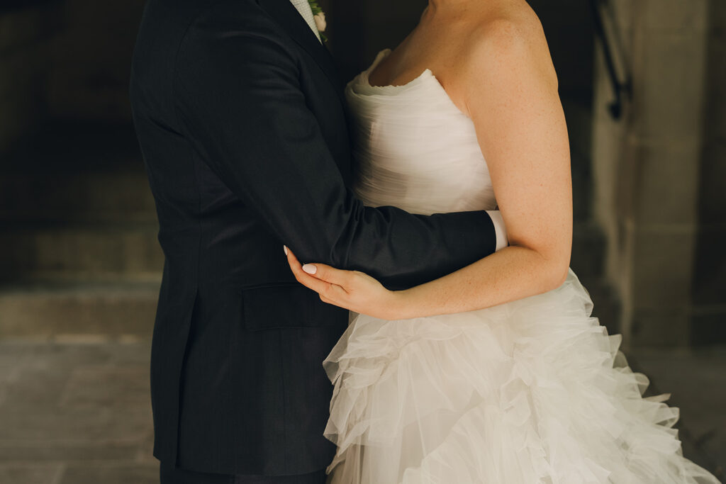 bride and groom hugging 