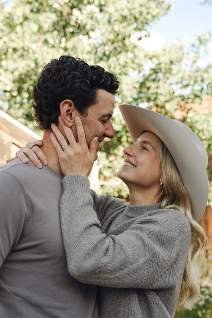 happy newly engaged couple looking at each other 