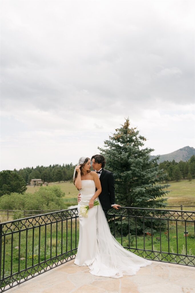 groom kissing the bride on the cheek