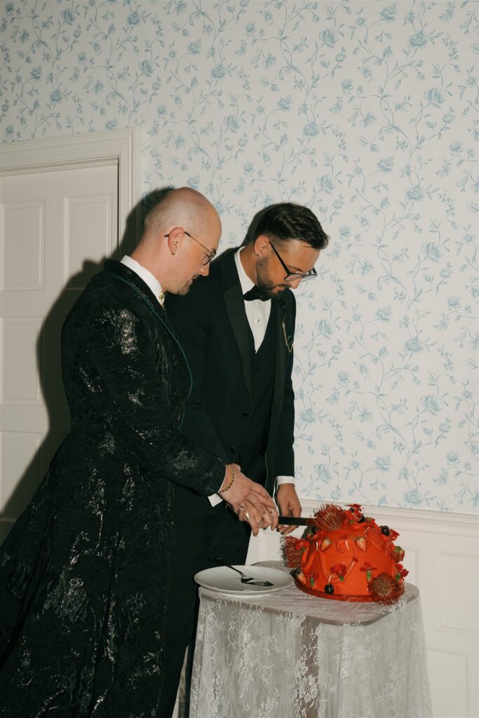 cute couple cutting their wedding cake